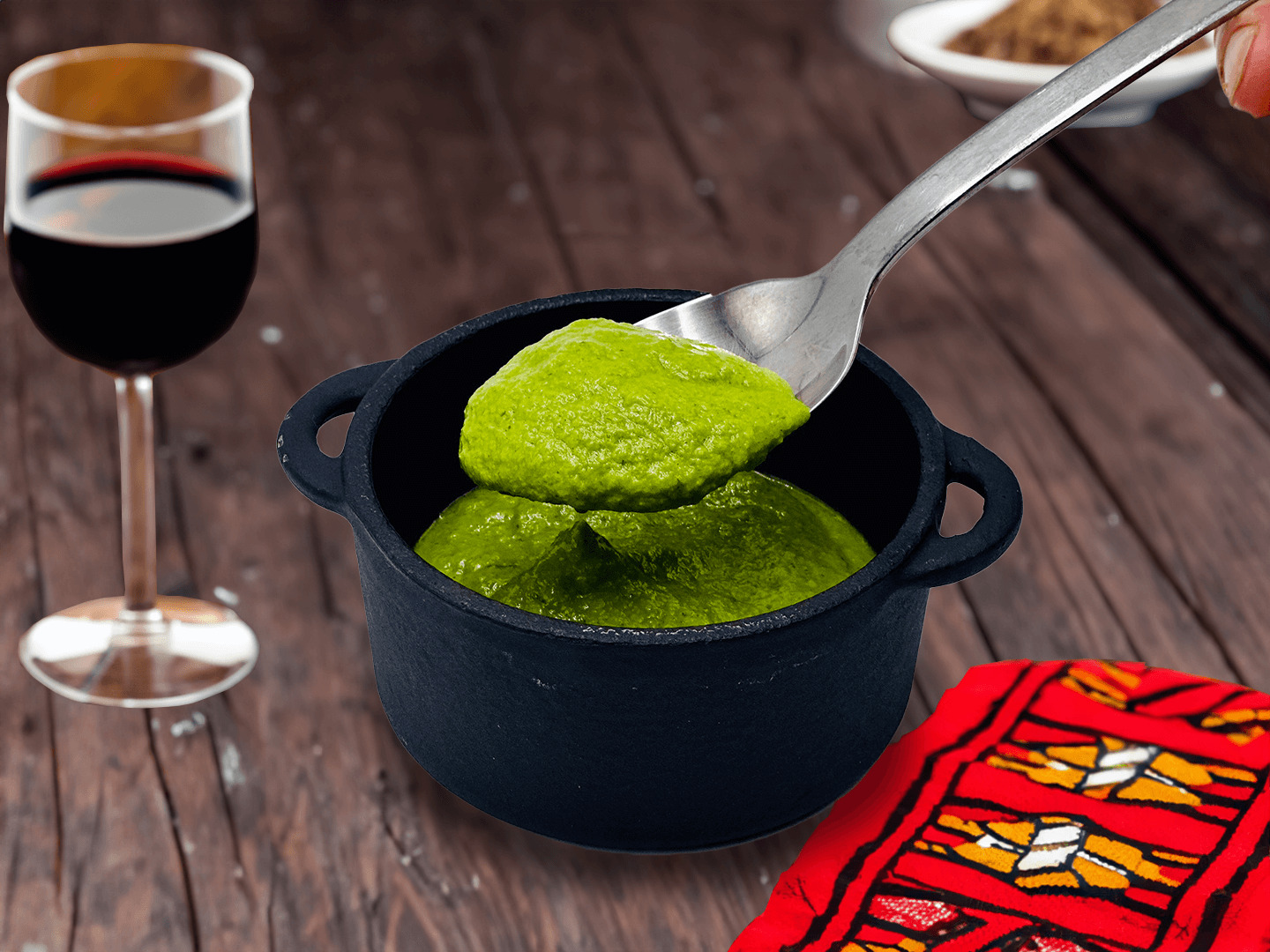 Green sauce in a small black pot