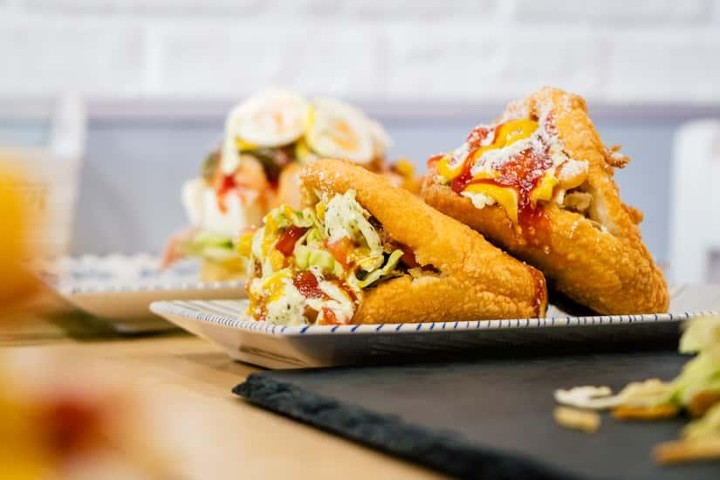 Assorted crispy snacks with colorful toppings and garnish